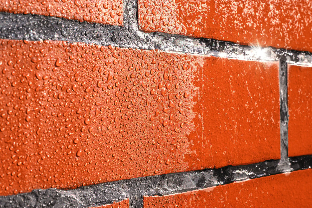 Natural stone with protective water-repellent treatment, droplets of water beading on the surface